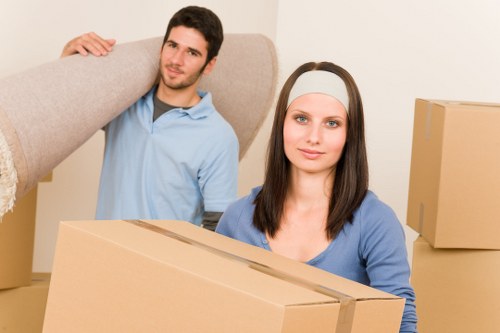 Local movers carrying boxes near Falconwood residential streets