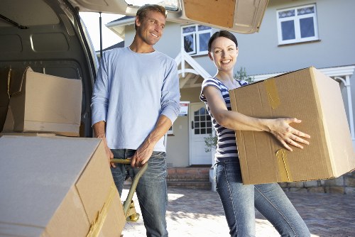 Falconwood moving team loading household items into a van